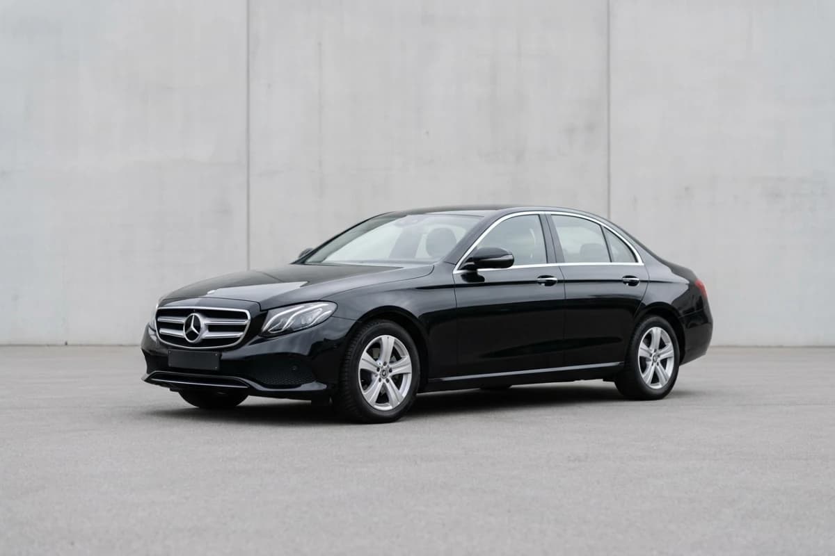 A black Mercedes E-Class, seen at an angle from the front